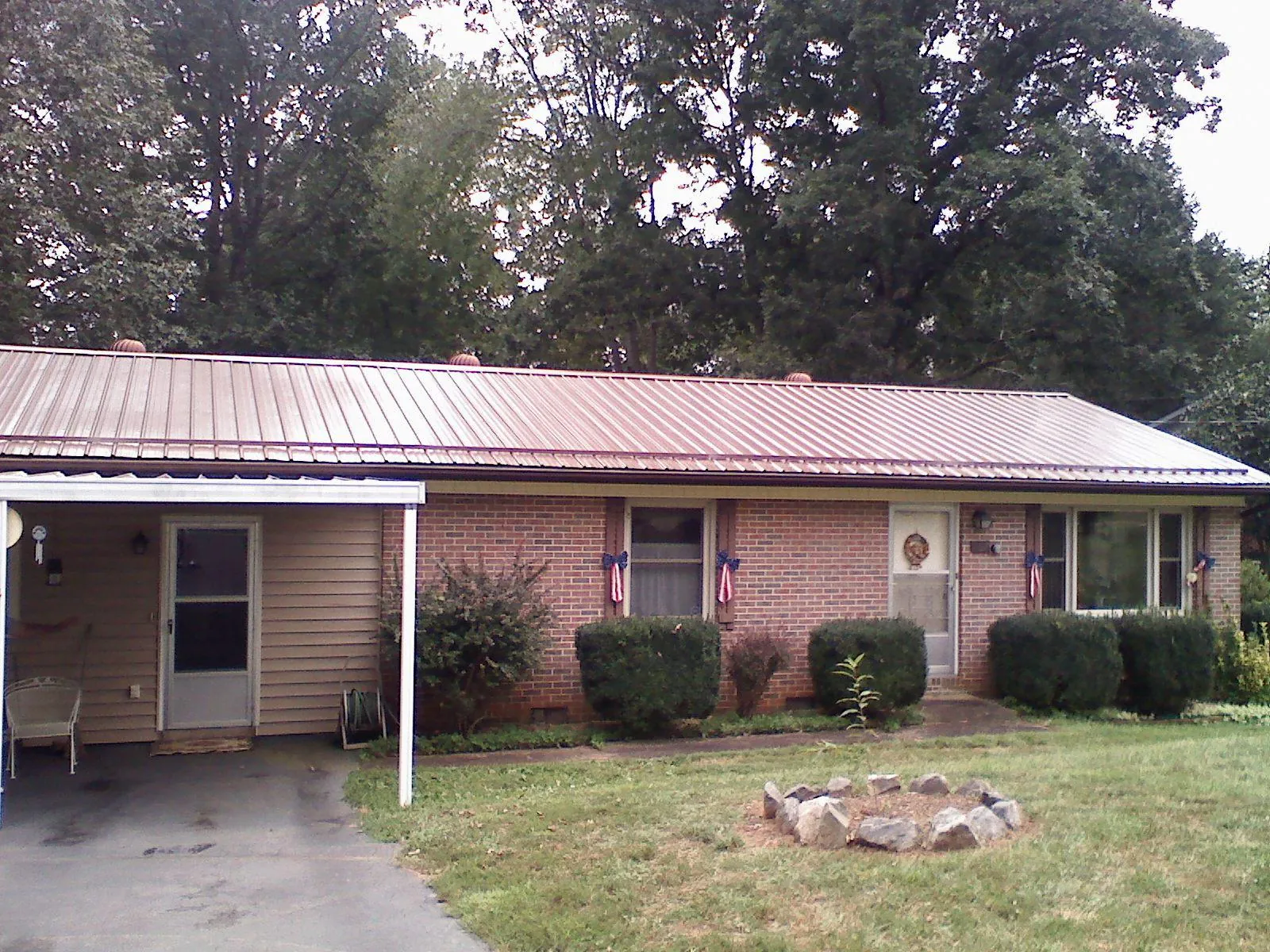 Bronze metal roof and carport on a brick ranch home — Roof Repair work by our crew in Paragon